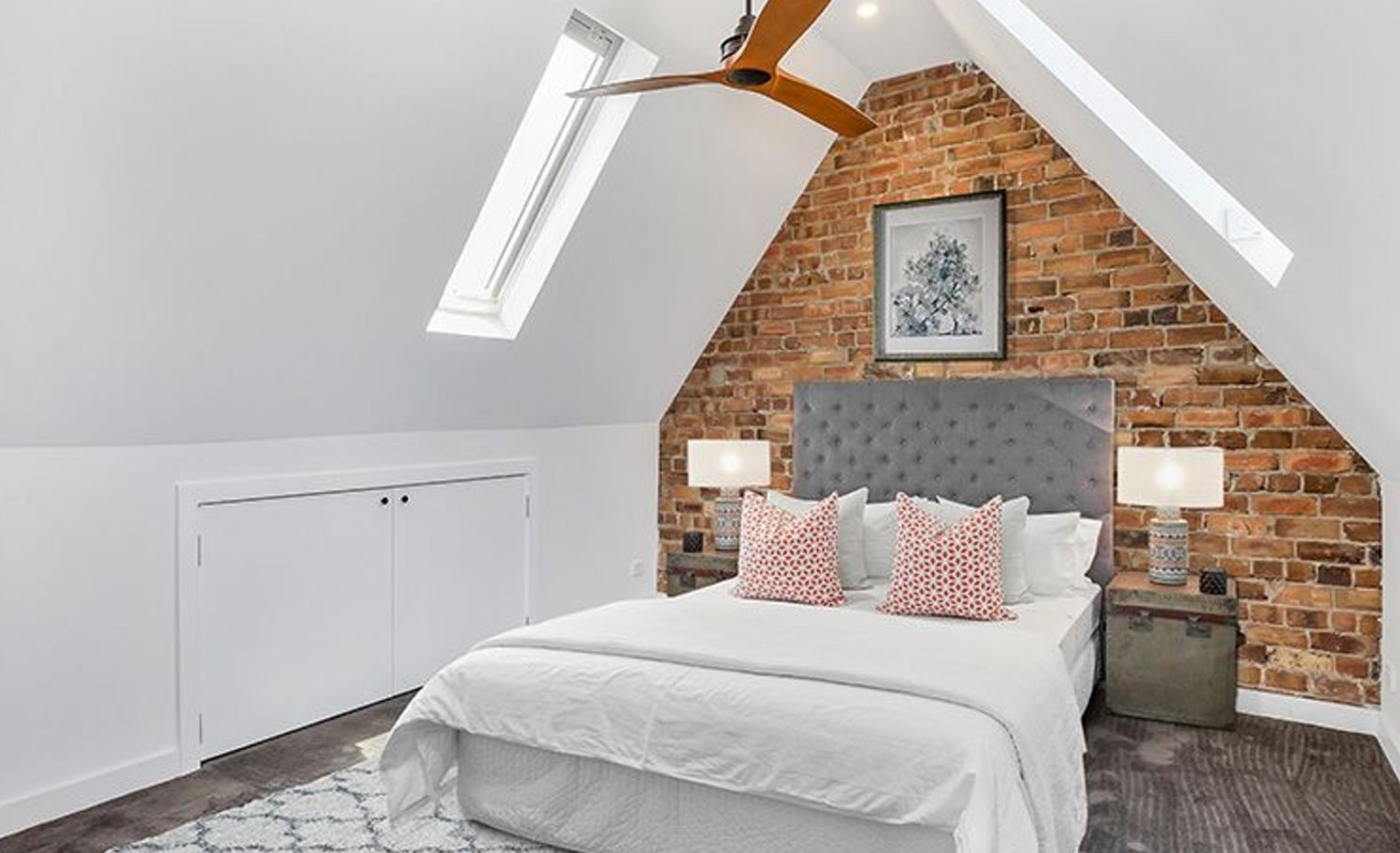 Arncliffe attic after - master bedroom with exposed brick wall