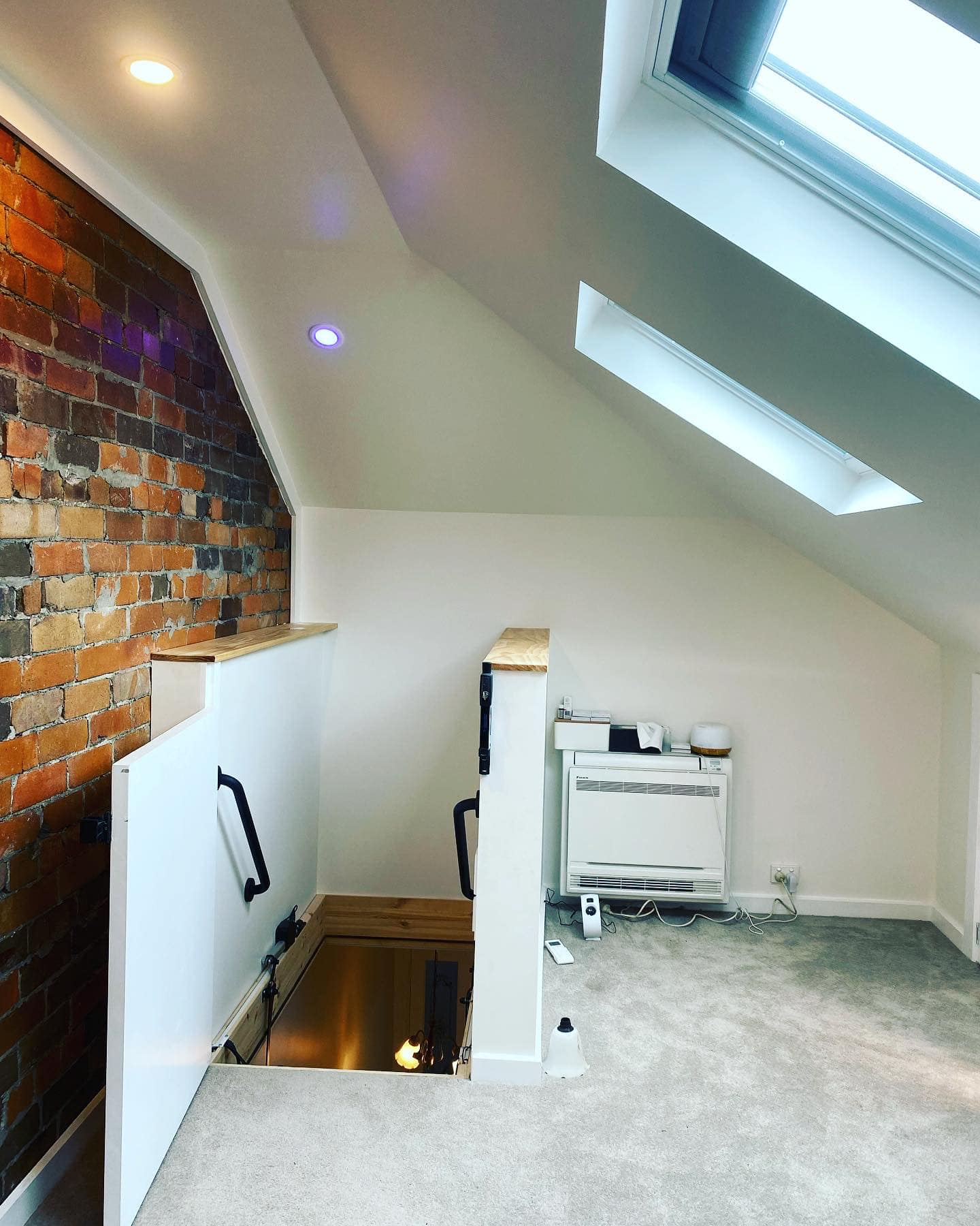Marrickville attic showing exposed brick wall and stair opening