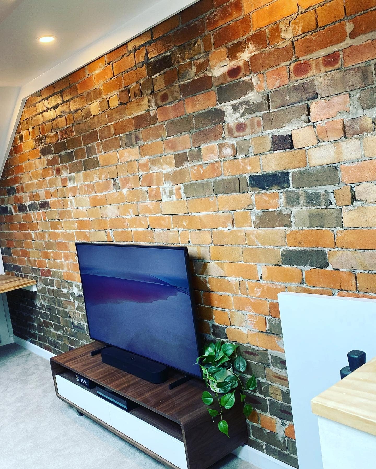 Marrickville media room with TV on exposed brick feature wall