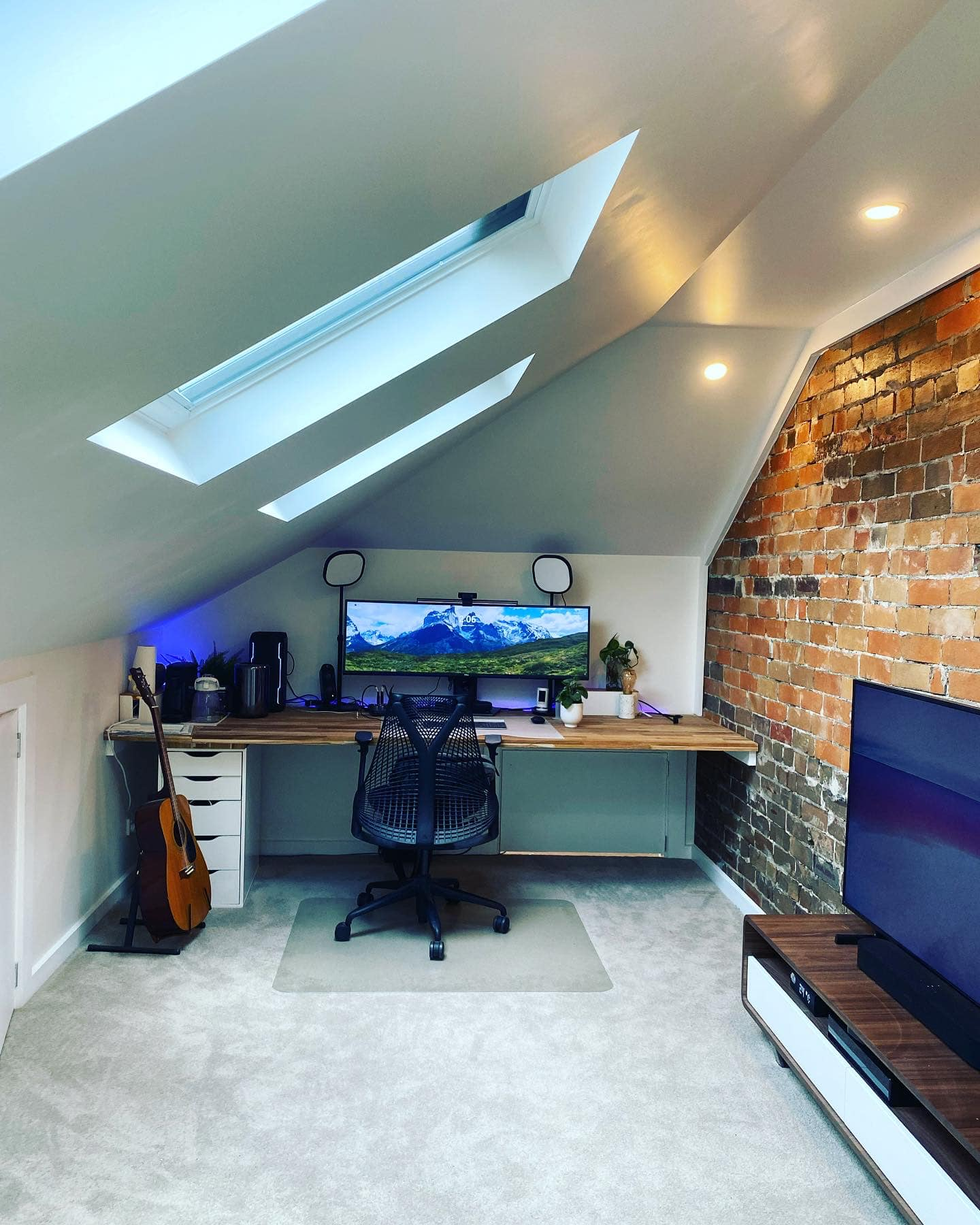 Premium attic home office conversion with exposed brick feature wall, skylights and built-in desk in Sydney