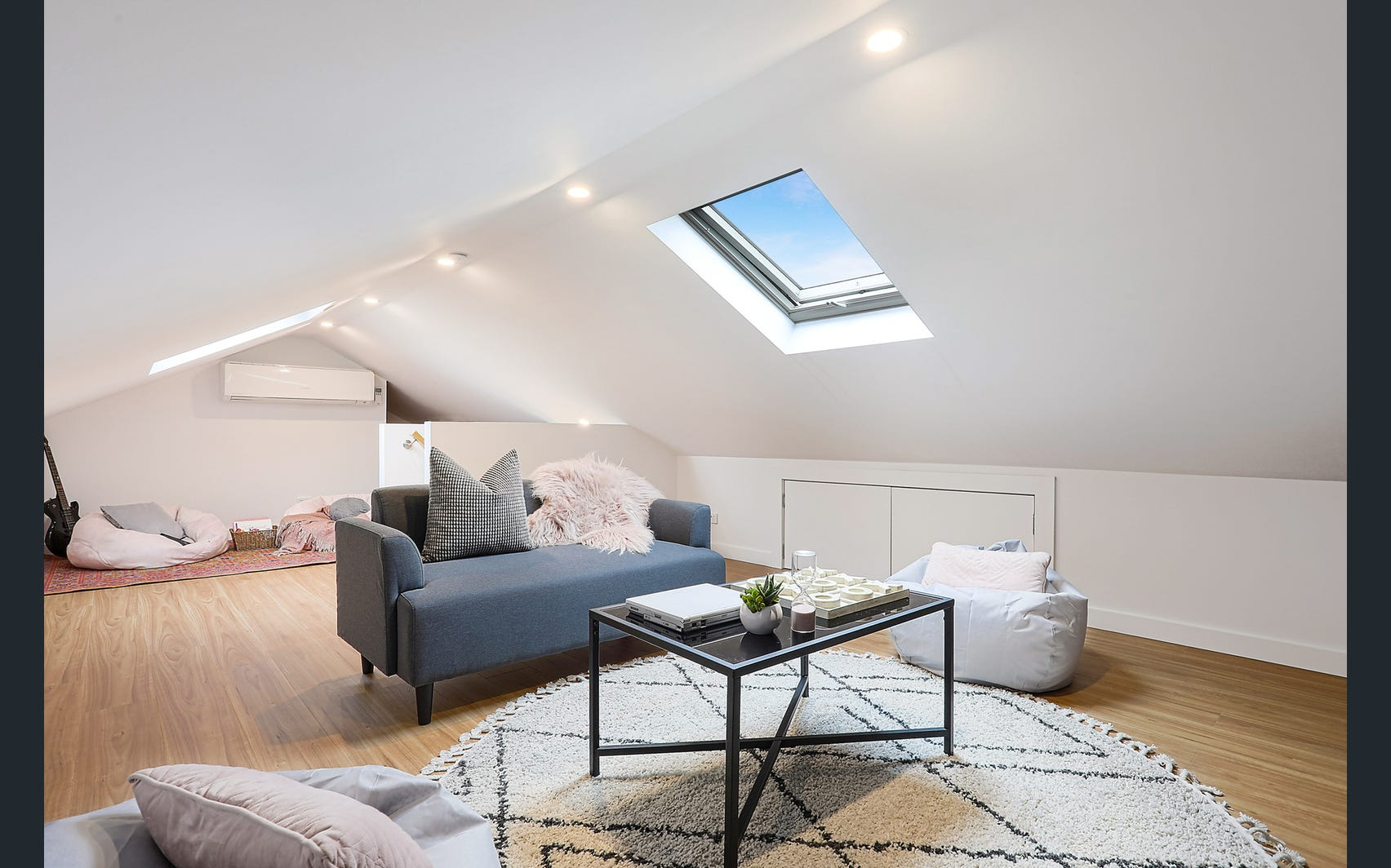 Randwick attic lounge with skylight, sofa and built-in storage