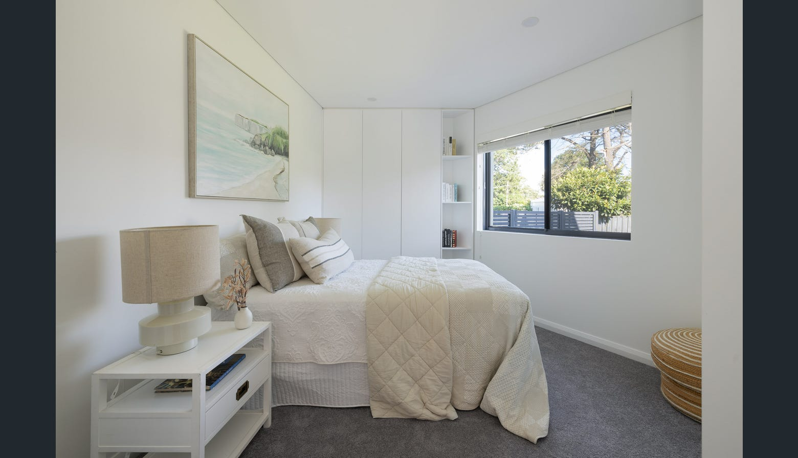 Ryde guest bedroom with coastal artwork and built-in storage