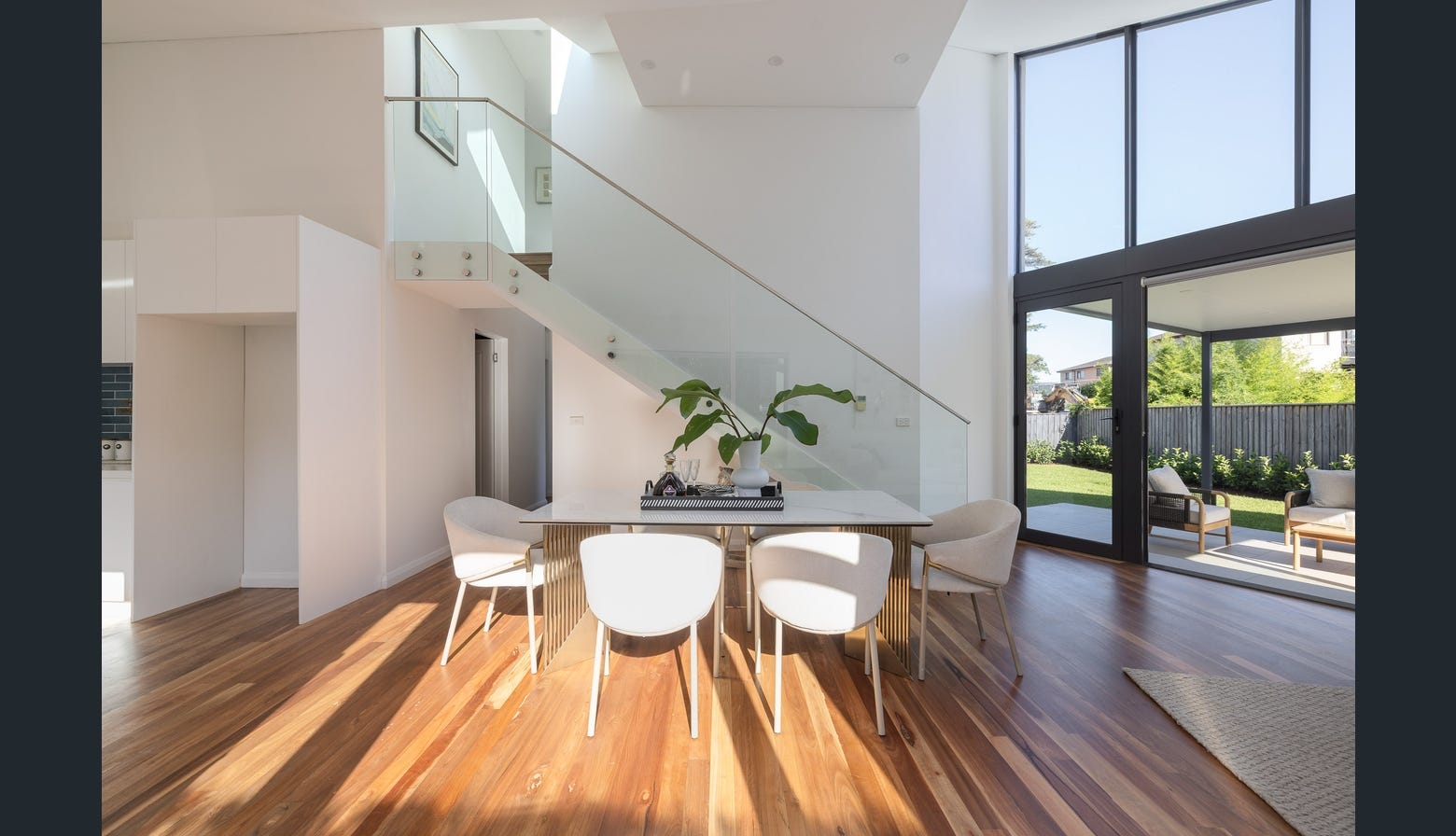 Ryde dining area with modern staircase and garden views