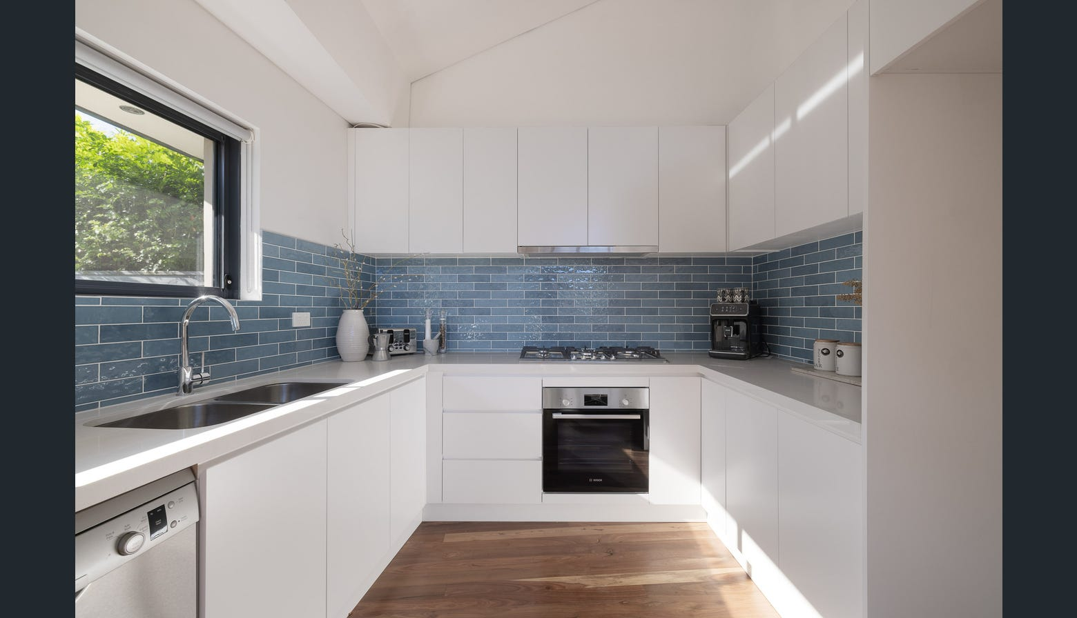 Ryde renovated kitchen with blue subway tile and white cabinetry