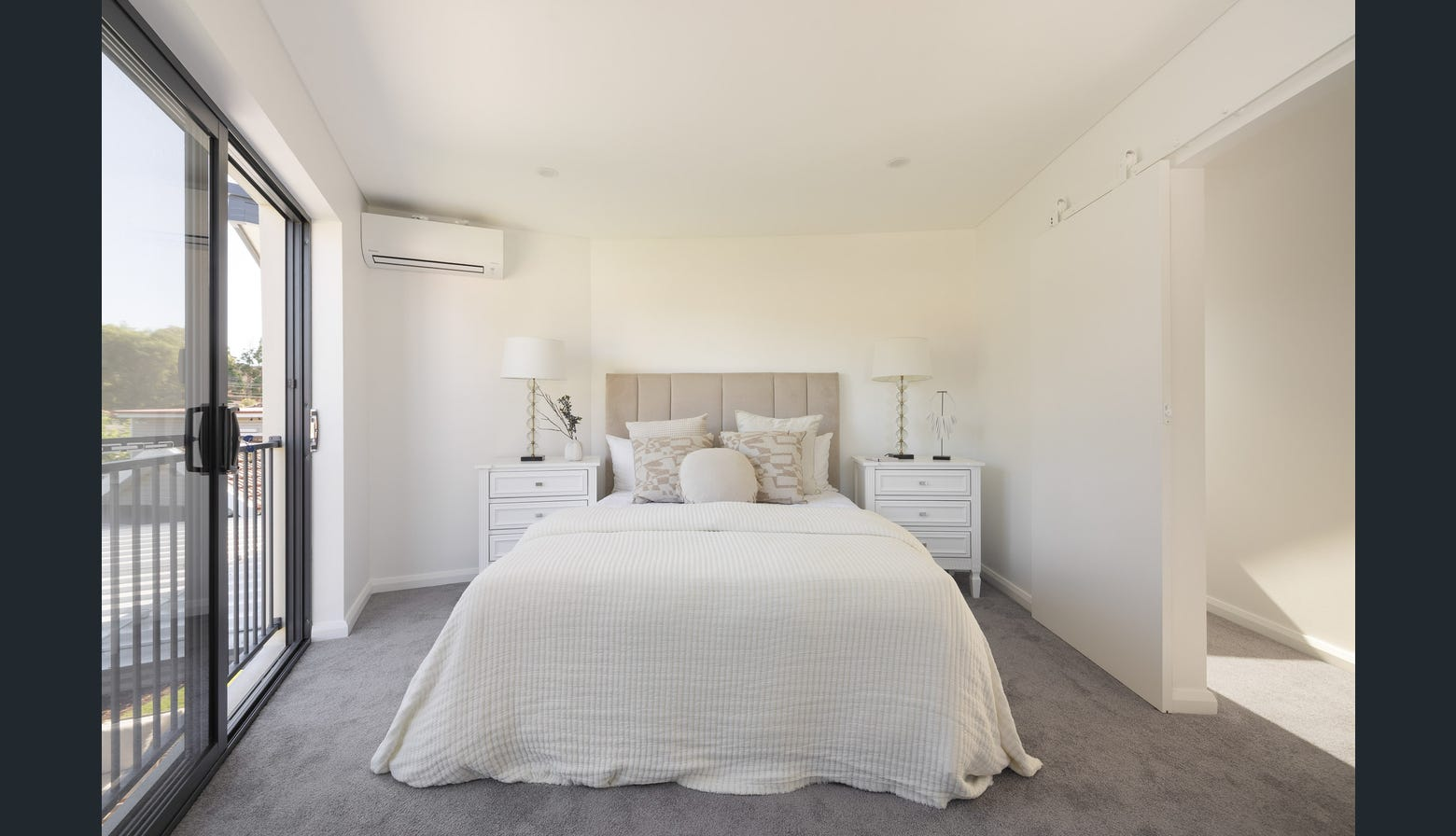 Ryde master bedroom with balcony access and air conditioning