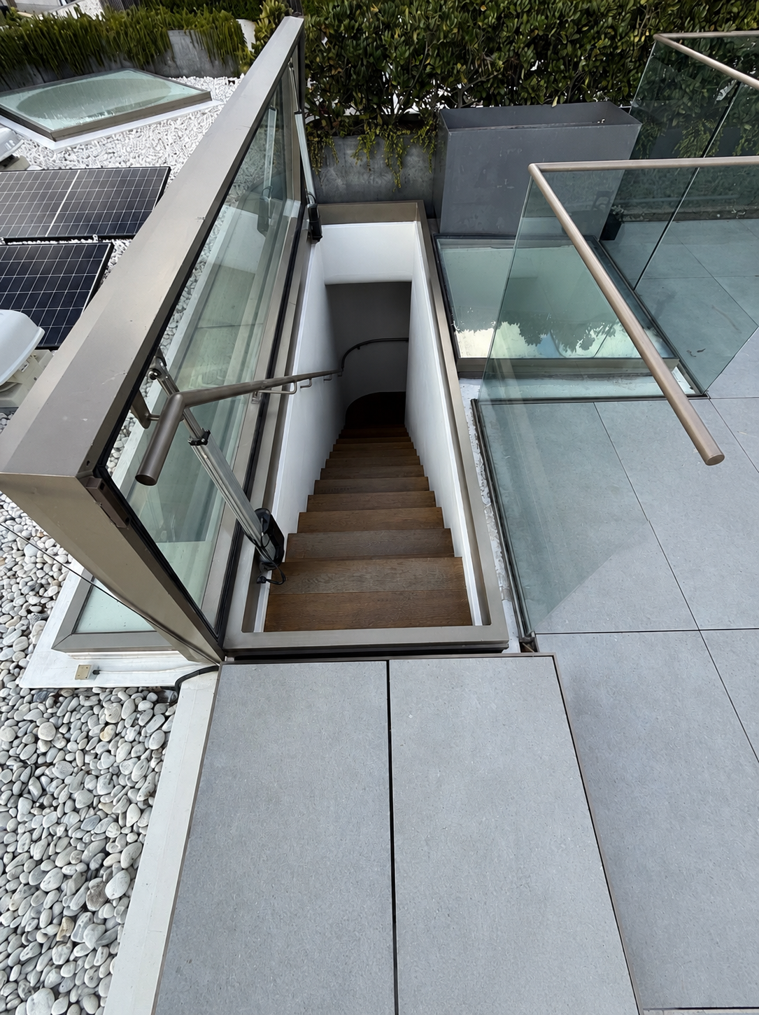 Atlite Skydoor rooftop access hatch open showing wooden stairs leading to rooftop terrace in Sydney